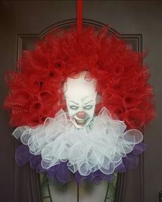 an image of a clown's head with red and white hair on top of it