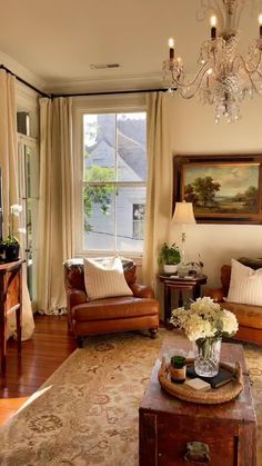 a living room filled with furniture and a chandelier