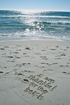 the words happy new year written in the sand at the beach