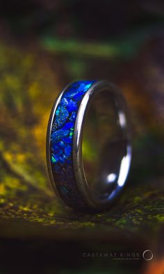 Here I have an opportunity for you to own a magnificent lapis lazuli and blue opal ring encased in an 6mm wide tungsten carbide core.  This ring is handmade by myself with only AAA grade deep blue Lapis Lazuli gemstone. The gems have been crushed into a small chunks, hand picked and inlayed 1 by 1 for the best fit of the pieces. If you didn't know Lapis Lazuli has a vast history being praised by the Ancient Egyptians, Romans and Greeks for its beautiful colours and the mystical powers that's why Mens Lapis Lazuli Ring, Opal Inlay Ring Gift, Opal Ring With Inlay Perfect For Gifts, Gift Opal Inlay Ring, Blue Opal Inlay Ring For Anniversary, Blue Opal Round Ring, Blue Opal Ring With Inlay For Anniversary, Blue Round Opal Ring, Blue Opal Promise Ring