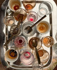 a tray filled with cups and saucers on top of a table