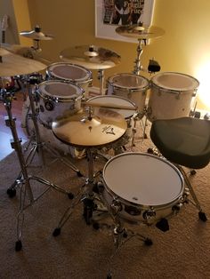 a drum set sitting on top of a carpeted floor