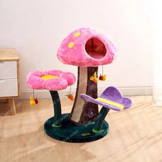 a pink mushroom house with flowers on the floor