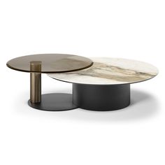 two tables with marble tops and metal bases, one is black and the other is white