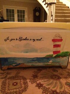 a box with a lighthouse painted on it sitting in front of a stair case that says if you're to gaudi in my mind