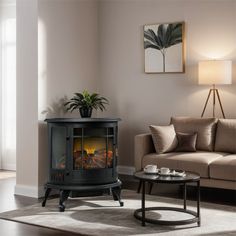 a living room with a couch, coffee table and a fire place in the corner