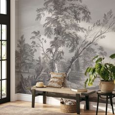 a living room with a bench and wall mural