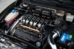 the engine compartment of a car with an oil can and some other items in it