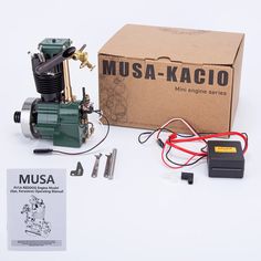 an engine and parts are shown in front of a box