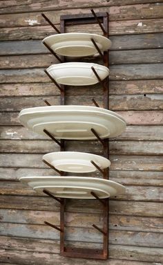 four surfboards are stacked on top of each other in front of a wooden wall