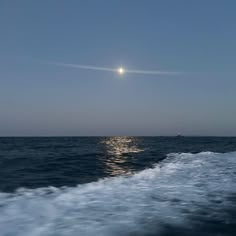 the sun shines brightly over the ocean as it travels through the water on a boat