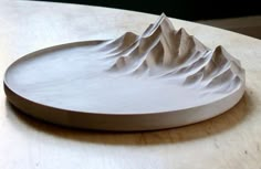 a white plate sitting on top of a wooden table