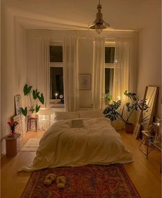 a bedroom with a large bed and lots of plants