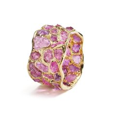 A barrel ring encrusted with brilliantly sparkling gemstones that have a truly opulent glow. They are encased in a setting of pure gold that is truly radiant in its shine and lusture.Details:Silver 925 Stones: Ruby RoughPlating: Gold 18KWidth: 11 mmBand wide: 11 mmLength: 23 mmWeight: 7.15 g Luxury Pink Sapphire Diamond Ring With Gemstone, Pink Sapphire Ring With Pave Setting, Elegant Multi-stone Pink Sapphire Diamond Ring, Luxury Pink Sapphire Ring With Pave Setting, Luxury Pink Sapphire Ring For Formal Occasions, Luxury Pink Sapphire Rings With Gemstone, Luxury Diamond Cluster Ring With Gemstones, Luxury Multi-stone Ruby Ring, Luxury Cluster Ring Gift