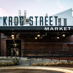 the entrance to krogs street market in an old brick building with metal railings