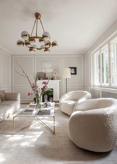 a living room filled with furniture and a chandelier