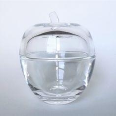 an apple shaped glass bowl with a lid