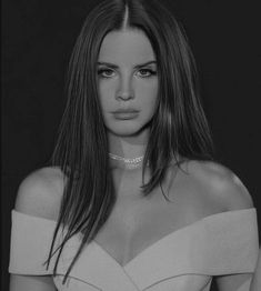 a black and white photo of a woman with long hair wearing a choker necklace