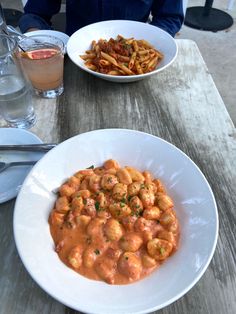 two plates of food on a wooden table