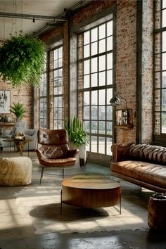 a living room filled with lots of furniture next to large windows and potted plants