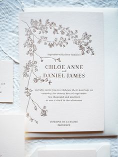 the wedding stationery is laid out on top of each other