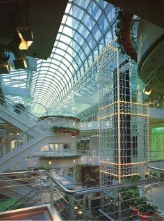 an indoor atrium with stairs and lights