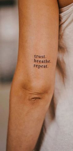 a person with a tattoo on their arm that says trust breathe repeat