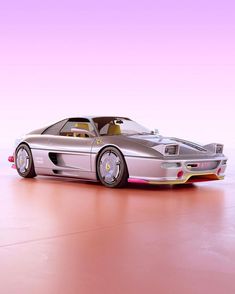 a silver sports car on a pink background