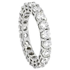 Introducing a perfect blend of classic design and modern aesthetic, this diamond ring is a timeless piece that transcends all ages. Crafted in lustrous 18Kt white gold, the ring features a feminine and elegant design that captures the essence of sophistication. Adorned with a stunning array of diamonds totaling 3.25 carats, this full eternity band showcases each stone in a classic, delicate 4-prong setting. The unique setting not only ensures maximum brilliance and sparkle but also adds a contem Luxury White Eternity Band With Vvs Clarity, Luxury White Diamond Eternity Band, Luxury White Gold Eternity Band Fine Jewelry, Diamond White Fine Jewelry Eternity Band, Luxury Gia Certified White Gold Eternity Band, Belgian Modern, Diamond Eternity Band, Eternity Band Ring, Modern Ring