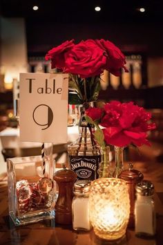 a table topped with candles and flowers next to a sign that says table 9 on it