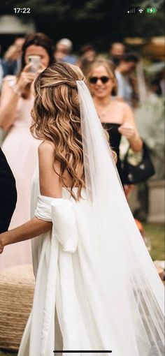 a bride and groom walking down the aisle