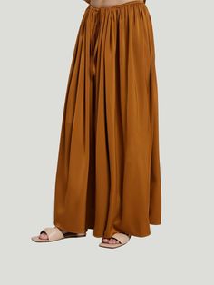 The DEPT.ANONYM Silky Wide Leg Pants are the epitome of luxury and style. These showstopping pants are one-size-fits-most, flowy wide-leg pants that can easily take you out on the town or to your next special occasion. Made from a satin-like material, these palazzo pants will have you feeling like royalty and looking like it too! The pant silhouette with a drawstring makes these pants a chic and effortless option for most body types. Additional Details: One Size Wide Leg Palazzo Pants Drawstring Silk Wide Leg Pants With Elastic Waistband, Wide Leg Silk Pants With Elastic Waistband, Silk Long Skirt For Fall, Silk Wide-leg Pants, Silk Wide Leg Bottoms With Elastic Waistband, Silk Wide-leg Bottoms With Elastic Waistband, Chic Wide-leg Harem Pants For Fall, Chic Fall Wide-leg Harem Pants, Elegant Wide Leg Harem Pants With Elastic Waistband