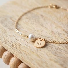 a close up of a bracelet on a wooden table