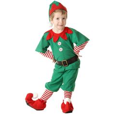 a little boy dressed in an elf costume for christmas time, standing on one leg