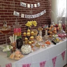 a table topped with lots of cupcakes and candy