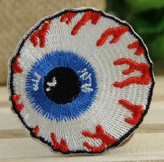 a close up of an embroidered object with red, white and blue colors