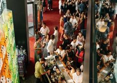 a crowd of people standing around a bar