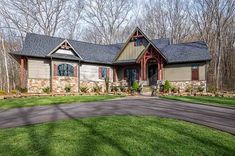 a large house with lots of windows in the front yard and landscaping on both sides