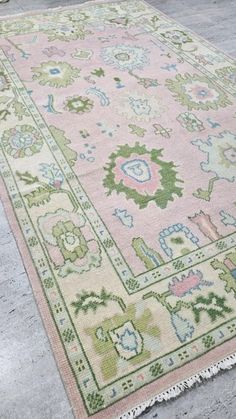 a pink and green rug on the ground