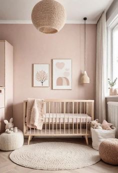 a baby's room with pink walls and neutral decor, including a crib