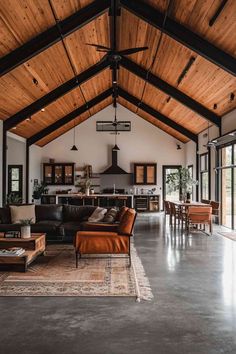 a large open living room with wooden ceilings