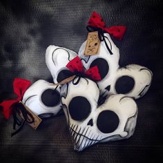 a pile of skulls with red bows on them