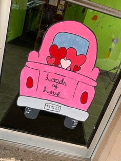 a pink car with hearts in the back window is painted on to it's side