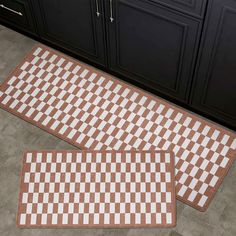 two brown and white checkered rugs sitting on the floor next to each other