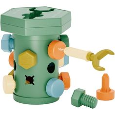 a green and yellow plastic toy with an apple on it's side, surrounded by other toys