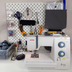 a sewing machine sitting on top of a table next to scissors and other crafting supplies