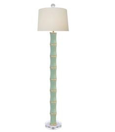 a green lamp with a white shade on it's base and a gold trim