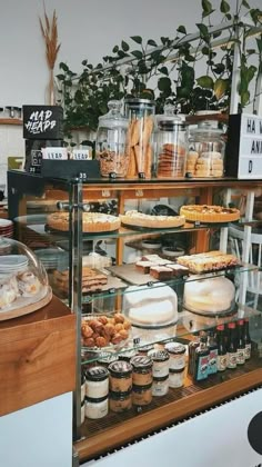 a display case filled with lots of different types of food and desserts on top of wooden shelves