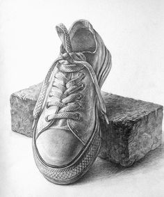 a pencil drawing of a pair of shoes sitting on top of a piece of wood