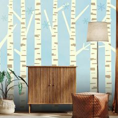 a living room with a wallpapered background and wooden cabinet in the foreground